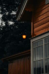Home exterior glowing with warm light against a dark evening sky
