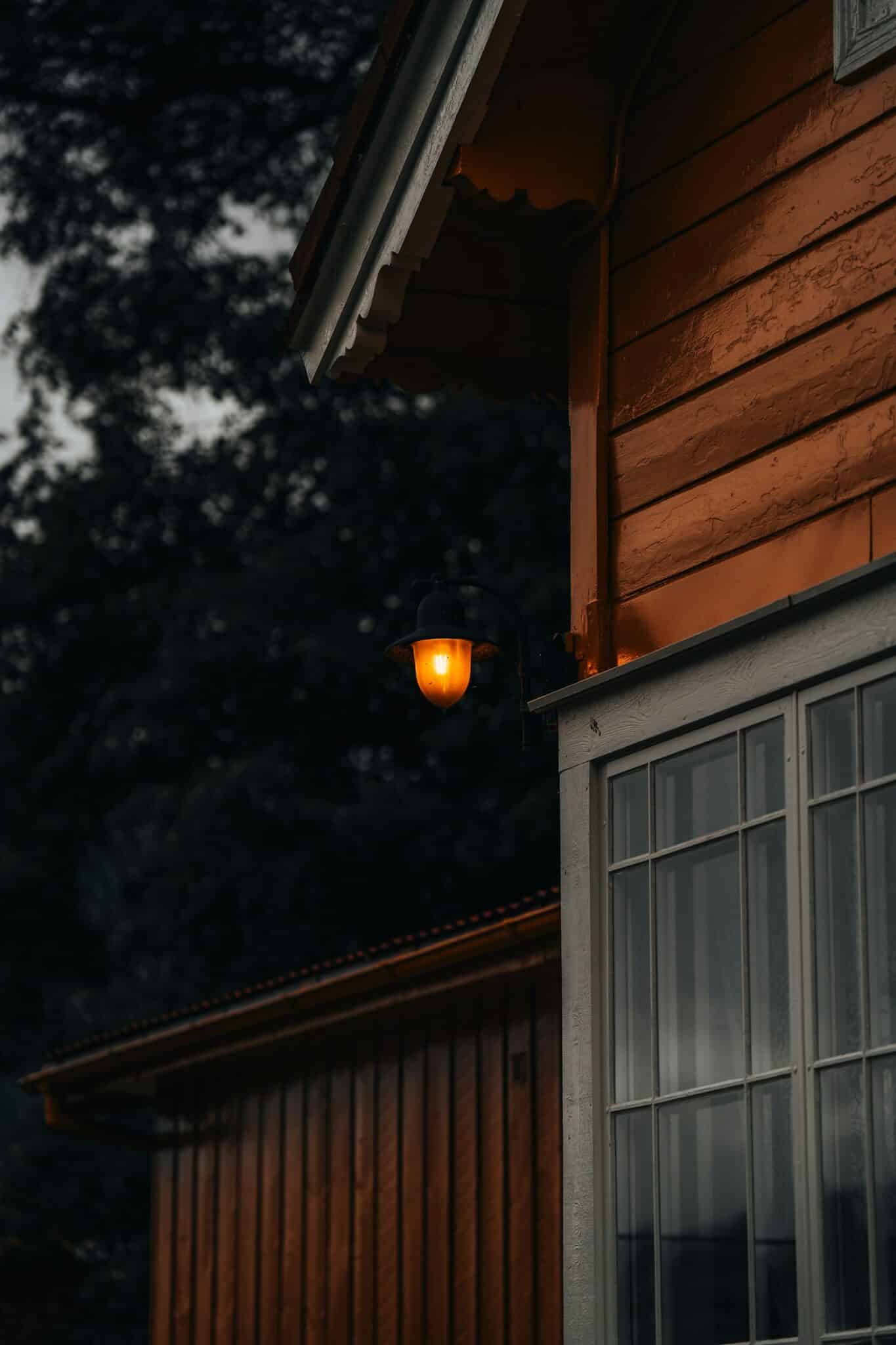 Home exterior glowing with warm light against a dark evening sky
