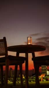 Candlelit table on an open-air patio at dusk