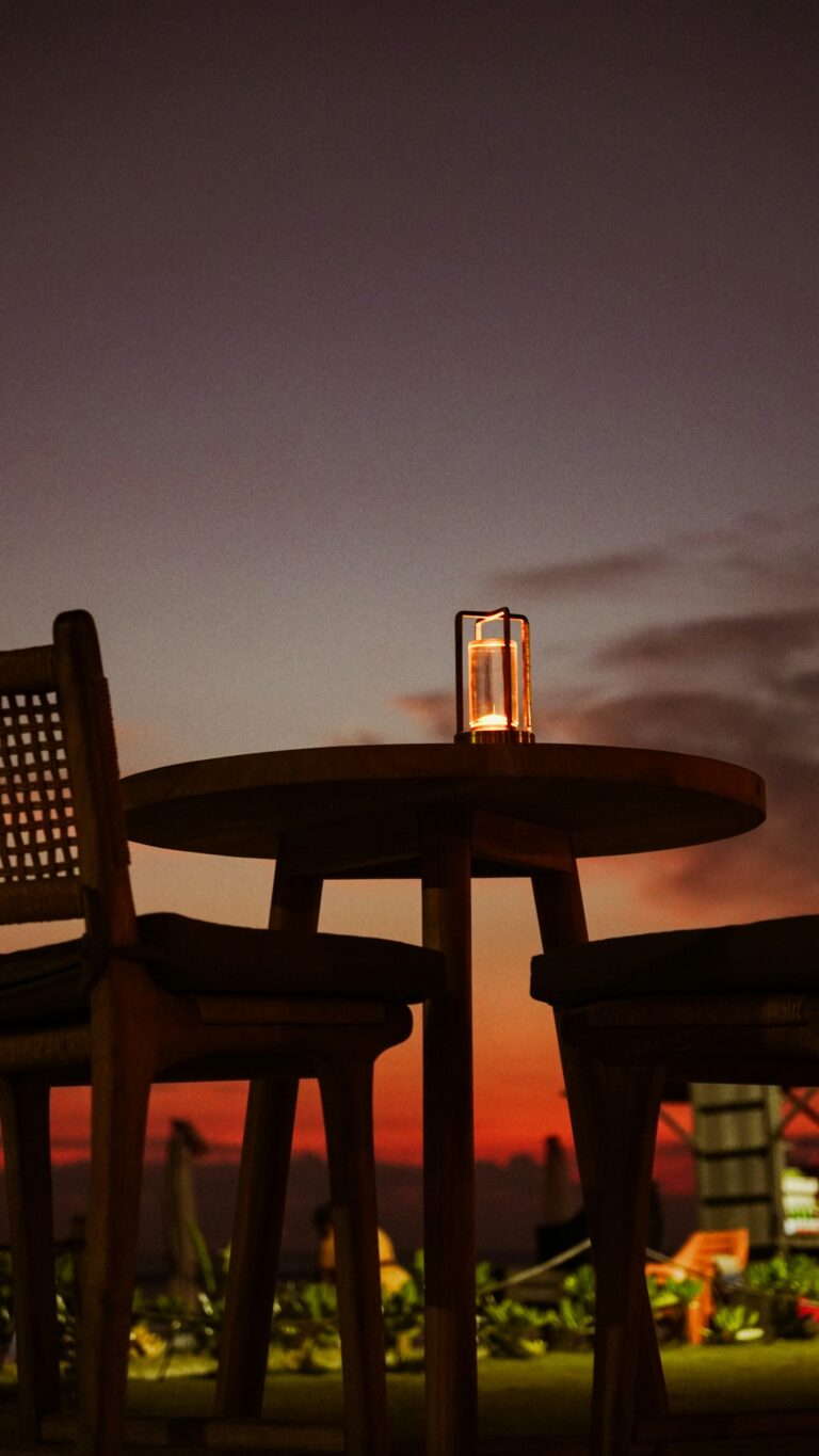 Candlelit table on an open-air patio at dusk